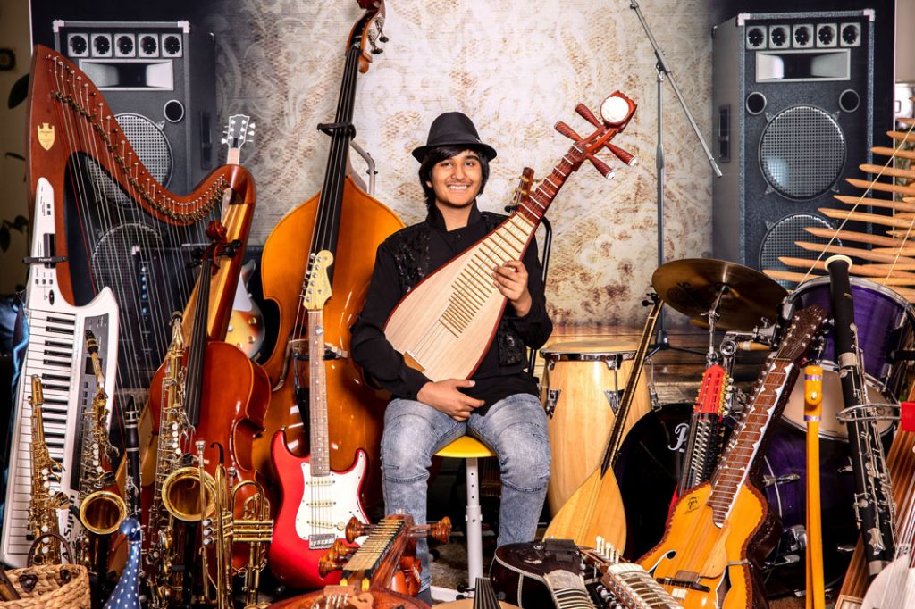 Neil Nayyar surrounded by many of the musical Instruments he loves play | California Pretty Magazine