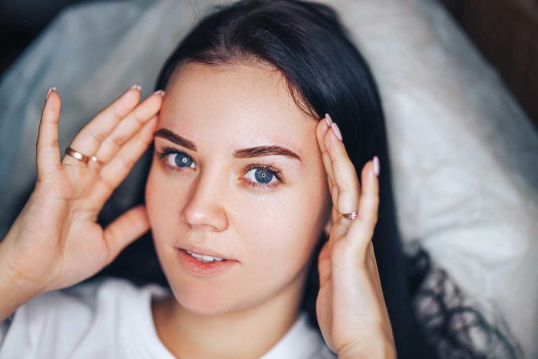 Young Teen Girl with Beautiful Eyebrows After Procedure Permanent Make-up in Salon